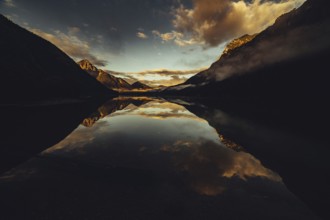 Sunrise with reflections in Lake Heiterwanger See in Tyrol in the Alps in Austria