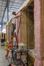Romulus, Michigan - Workers build apartments in Ginosko Modular 's factory using modular