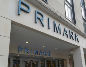 Signs above entrance doorway to Primark shop store, Torquay, Devon, England, UK