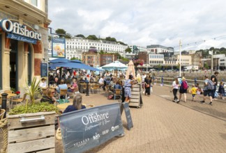 Offshore bar and restaurant, people walking on quayside, Vaughan Parade, Torquay, Devon, England,