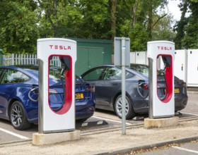 Tesla Supercharger station charging bays for electric vehicles at service station, M25 South Mimms