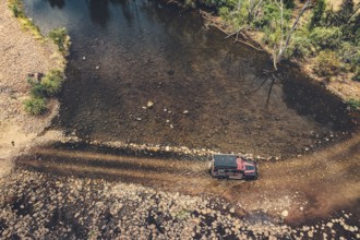 Landrover crosses river in Australian outback in the Kimberley, North West Australia, Australia