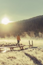 Young woman at Lake Staz near Sankt Moritz in the Engadine in Switzerland. Morning atmosphere with