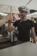Young man riding a racing bike on Lake Garda. Sunny weather and dolce vita