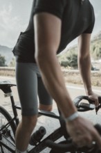 Young man riding a racing bike on Lake Garda. Sunny weather and dolce vita