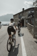 Woman and man cycling on Lake Garda in Italy. Sunny weather and dolce vita