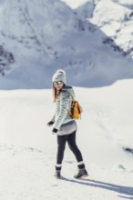 Woman in wintry surroundings in the Engadine in Switzerland