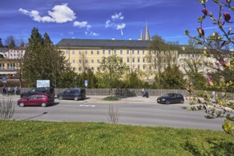 Royal Castle Berchtesgaden, general development, lawn, parking lane with vehicles, wooden fence,