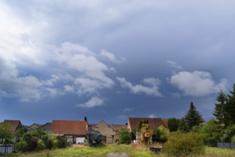 Gathering storm over a village, Lower Franconia, Bavaria, Germany