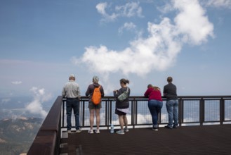 Colorado Springs, Colorado - Tourists line a viewint platform at the summit of Pikes Peak, a 14,