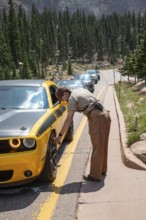 Colorado Springs, Colorado - A Pikes Peak ranger checks the temperature of brakes on a car