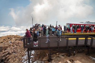 Colorado Springs, Colorado - Arriving passengers on the Manitou and Pikes Peak Railway flock to the