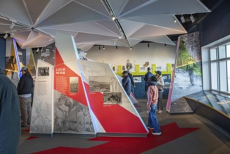 Colorado Springs, Colorado - Tourists view displays in the Summit Visitor Center at Pikes Peak, a