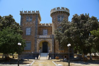 Bellinis Tower, Museum, Historical building with battlements and towers in front of a blue sky,