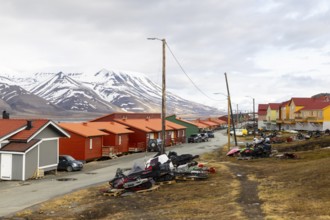 Colourful wooden houses, street, skidoos, Longyearbyen, Spitsbergen, Svalbard
