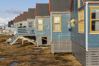 Colourful houses with exposed supply lines, Longyearbyen, Spitsbergen, Svalbard
