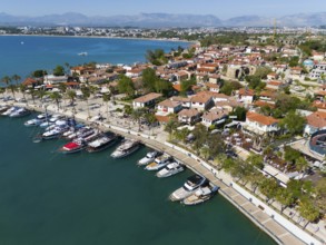Scenic harbour with boats and palm trees along the coastline of a town, aerial view, harbour, Side,