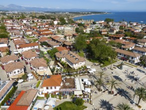 View of a Mediterranean town with red houses, palm trees and coastal view, aerial view, Side,