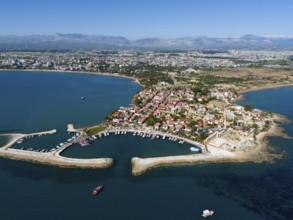Aerial view of a coastal town with boat harbour. Mediterranean houses and blue sea, aerial view,