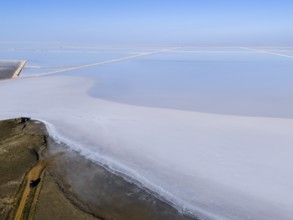 A vast salt landscape stretches out under a clear blue sky, aerial view, salt lake, Tuz Gölü,