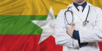 Male doctor with stethoscope on Myanmar flag. Doctor holding stethoscope on Myanmar flag