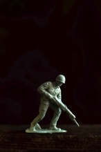 A small soldier figure stands ready with a rifle, capturing the essence of military readiness and