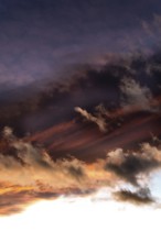 Vibrant clouds are illuminated by the setting sun, showcasing a blend of colors and textures in the