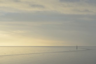 Wadden Sea at rising water, stone groyne with sea mark, North Sea, Norddeich, Lower Saxony, Germany