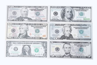 Various US dollar notes on white background, 1 dollar, 5 dollars, 10 dollars, 20 dollars, 50