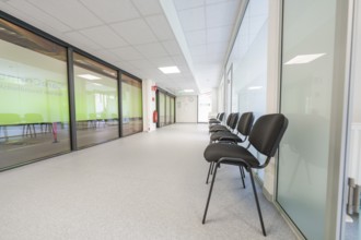 Modern, bright hallway with chairs and glass doors in the waiting area, Care Connect, vaccination