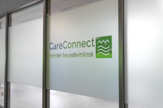 Glass wall with CareConnect logo in modern design and health kiosk lettering, Care Connect,