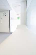 Treatment room with couch and CareConnect logo in minimalist style, Care Connect, vaccination kiosk