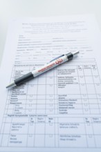 Biros on a completed form on a desk, Care Connect, vaccination kiosk for refugees, Calw, Germany