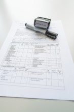 Form on a desk with stamp and marker, Care Connect, vaccination kiosk for refugees, Calw, Germany