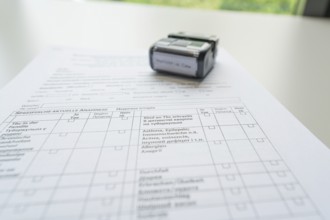 A completed form with a stamp on it, Care Connect, vaccination kiosk for refugees, Calw, Germany