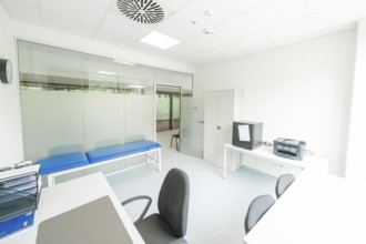 A bright examination room with couch and desk, Care Connect, vaccination kiosk for refugees, Calw,