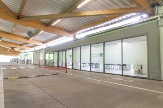 Modern building with glass front and car park at CareConnect, Care Connect, vaccination kiosk for