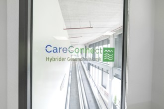 Bright escalator with CareConnect logo in a modern building, Care Connect, vaccination kiosk for