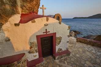 Legend, crab, shell fisherman, chapel with red roof and cross, directly on the rocky coast to the