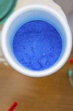 Close-up of a container with blue powder in a laboratory, Battery Research, Nagold, Germany
