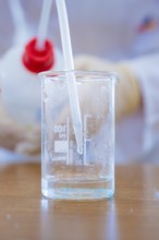 Pipette in a beaker filled with water in a laboratory, Battery Research, Nagold, Germany