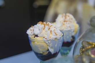 Two sundaes with cream and sprinkles on a table, decoratively arranged, Retro Freizeitpark