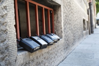 Key boxes on a grille of a basement window for flat flats in the city centre of Bratislava,