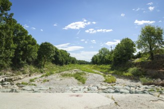Extensive dry riverbed of the Schwarza with vegetation and surrounding nature, Neunkirchen, Lower