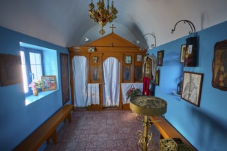 The interior of the church features icons and decorative elements in blue and orange, chapel,