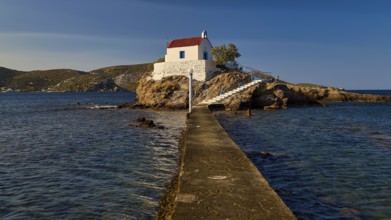 A pier leads to a church perched on a rock, surrounded by the calm sea, chapel, church, Agios