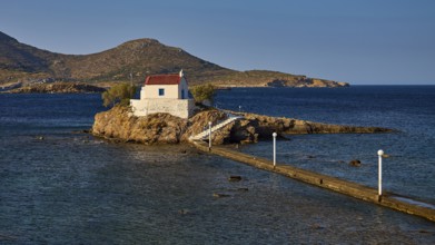 Quiet, peaceful coastal scene with chapel on rocky island, surrounded by blue water, chapel,