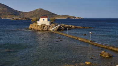 Calm scene with chapel on rocks in the sea under morning light, chapel, church, Agios Isidoros,