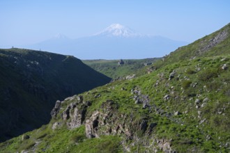 Wide green valley flanked by steep slopes, with Mount Ararat in the background, Our Lady Church
