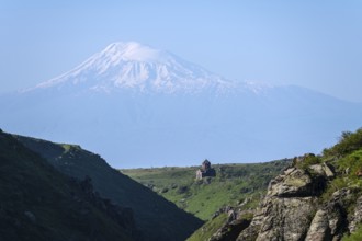 Small church in a valley dominated by snow-capped Mount Ararat under bright skies, Our Lady Church
